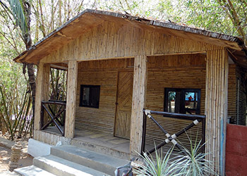An open plan cabin with double bed and set of bunks